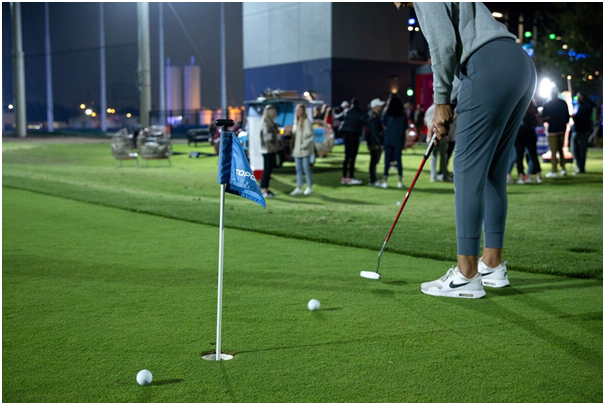 Girls playing golf on the course.